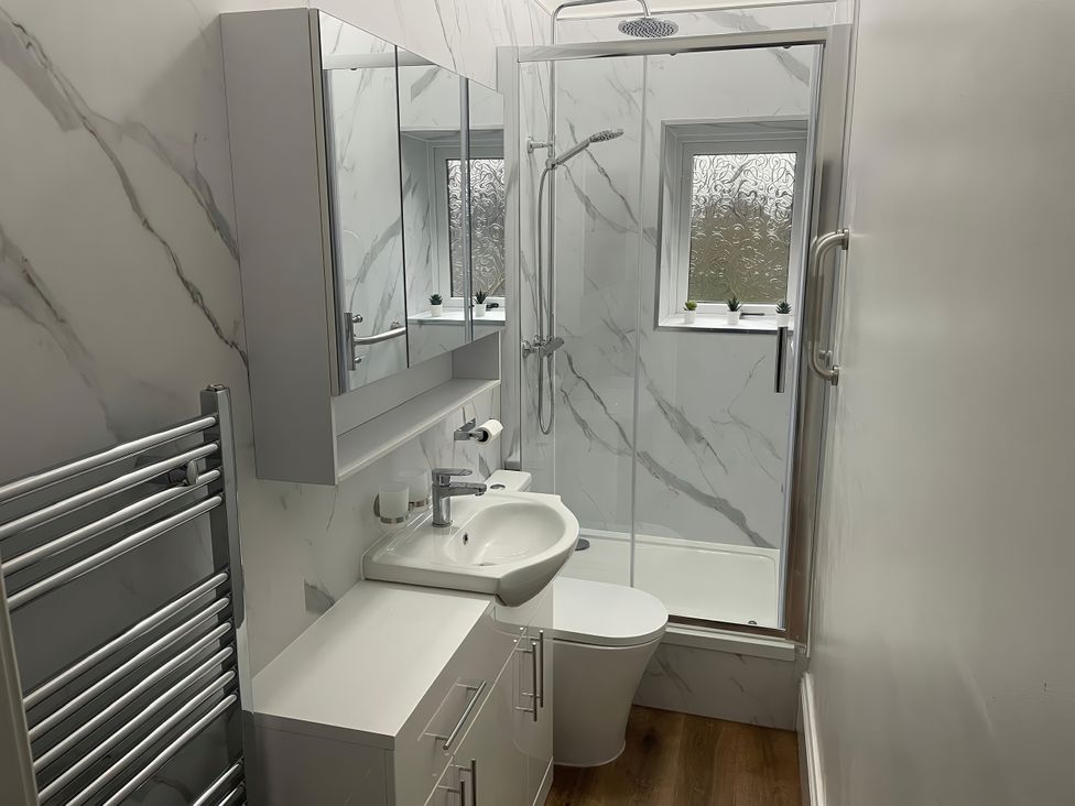 A bathroom with a shower and sink at Limpet Lodge in Tynemouth