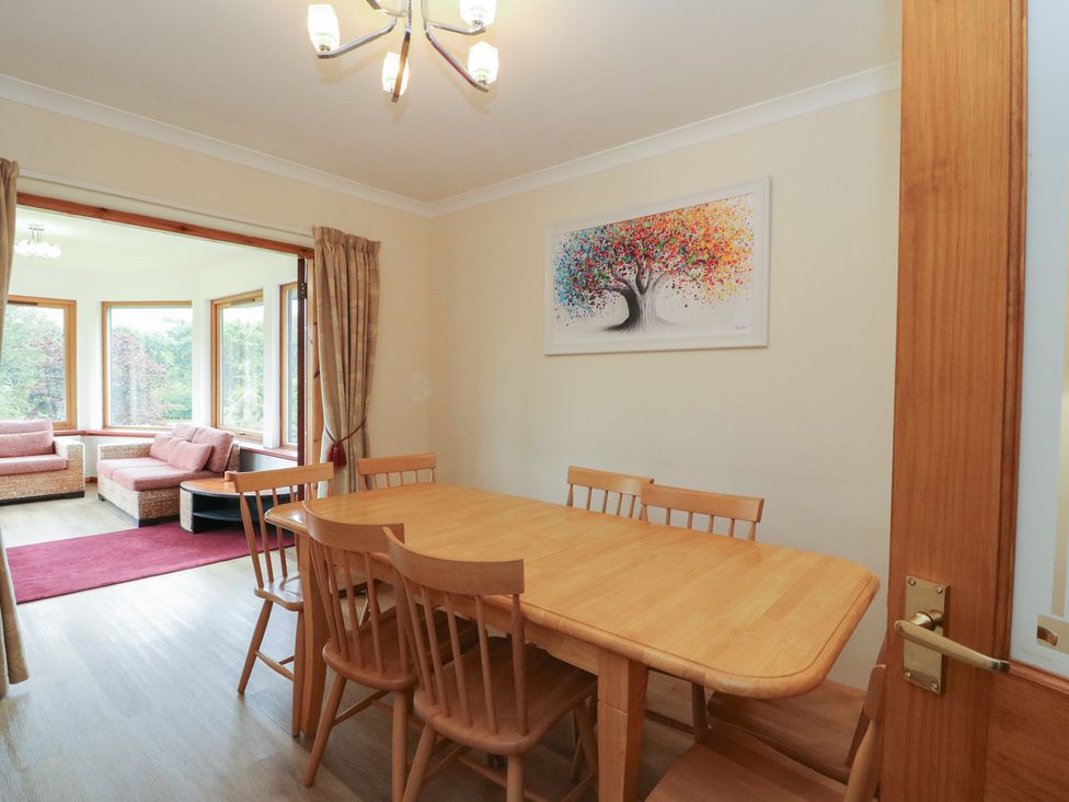 A dining room with a table and chairs at Maybank in Muirshearlich