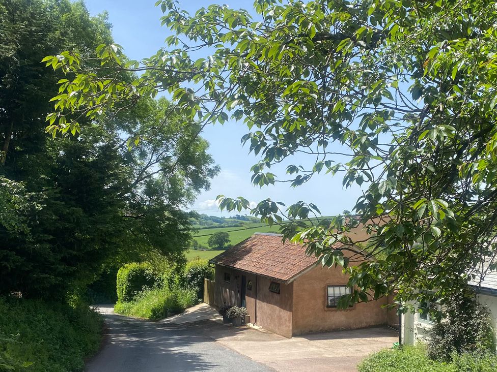 A view of a road with a house and trees at Church Farm Dairy Cadbury near Thorverton