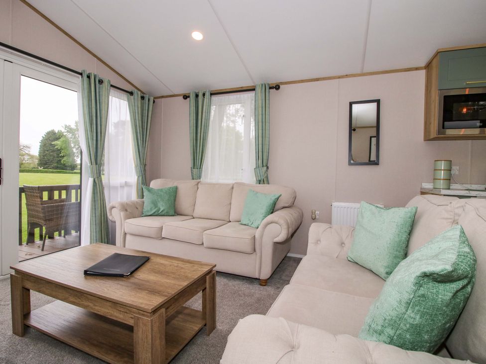 A living room with a sofa and coffee table at Owl in Shobdon