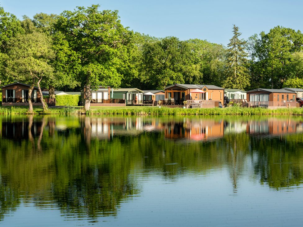 A view of caravans by a lake at Owl in Shobdon
