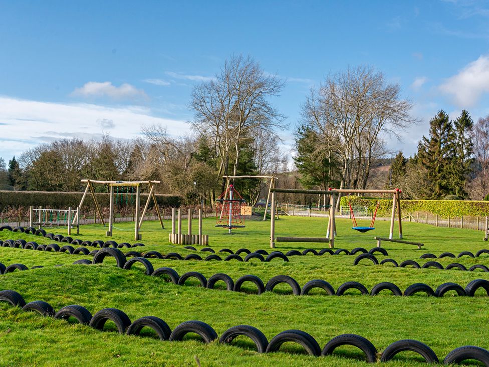 A play area with swings and climbing frame at Owl in Shobdon