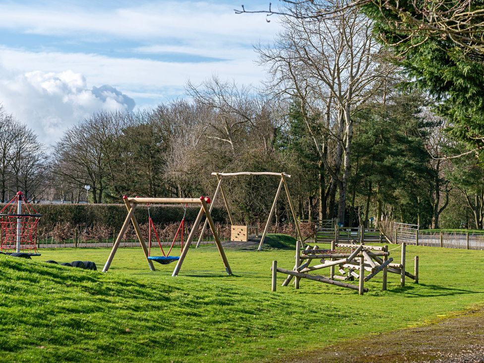 A playground with swings and climbing frame at Owl in Shobdon