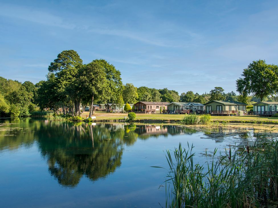 A view of caravans beside a lake at Owl in Shobdon