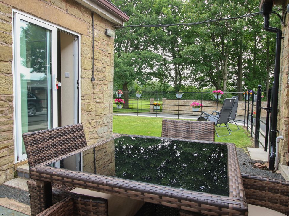 An outdoor area with a table and chairs at Stables Cottage in Shobdon