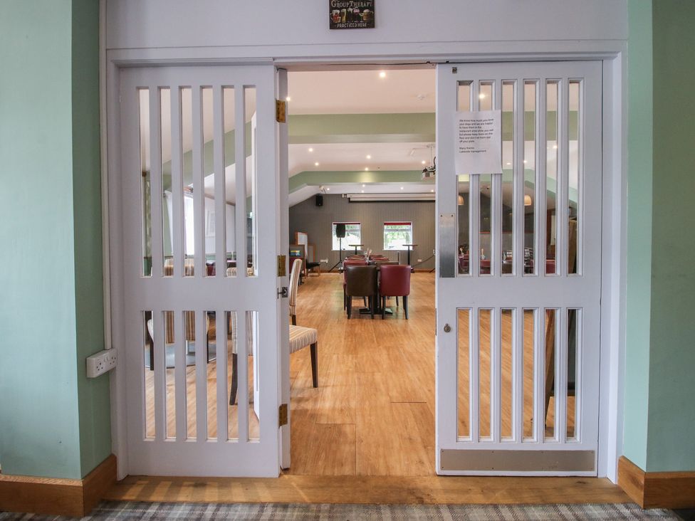 A view through doors into a dining area at Keepers Cottage in Shobdon