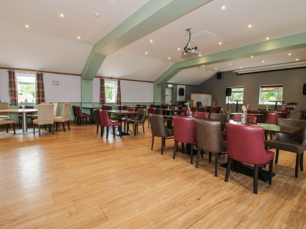 A dining room with tables and chairs at Keepers Cottage in Shobdon