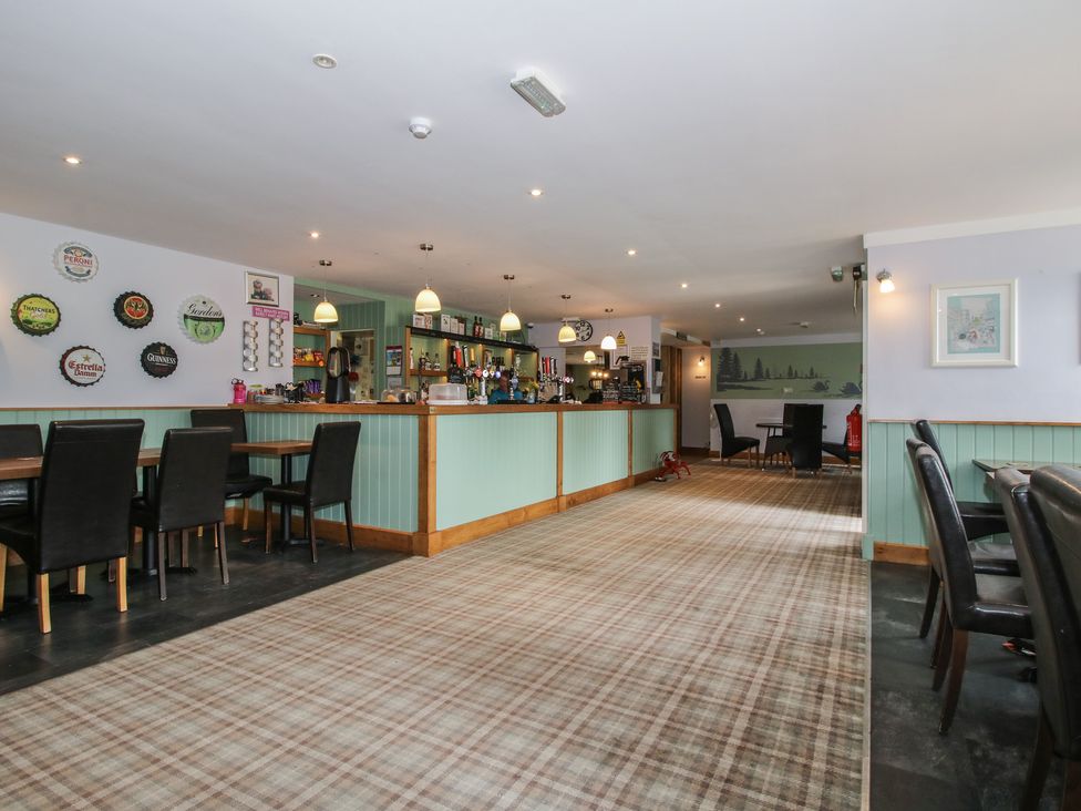 A bar area with tables and chairs at Keepers Cottage in Shobdon