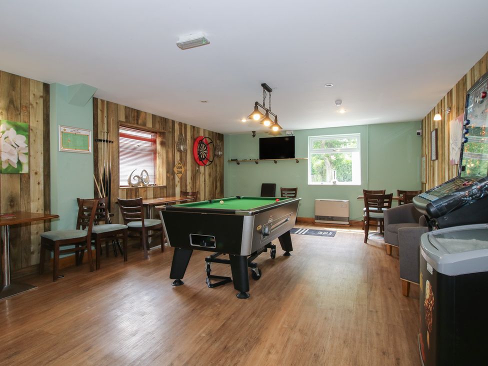 A snug with a pool table and dartboard at Keepers Cottage in Shobdon