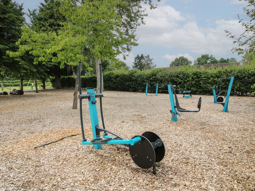 Outdoor gym with fitness equipment in a park at Keepers Cottage in Shobdon