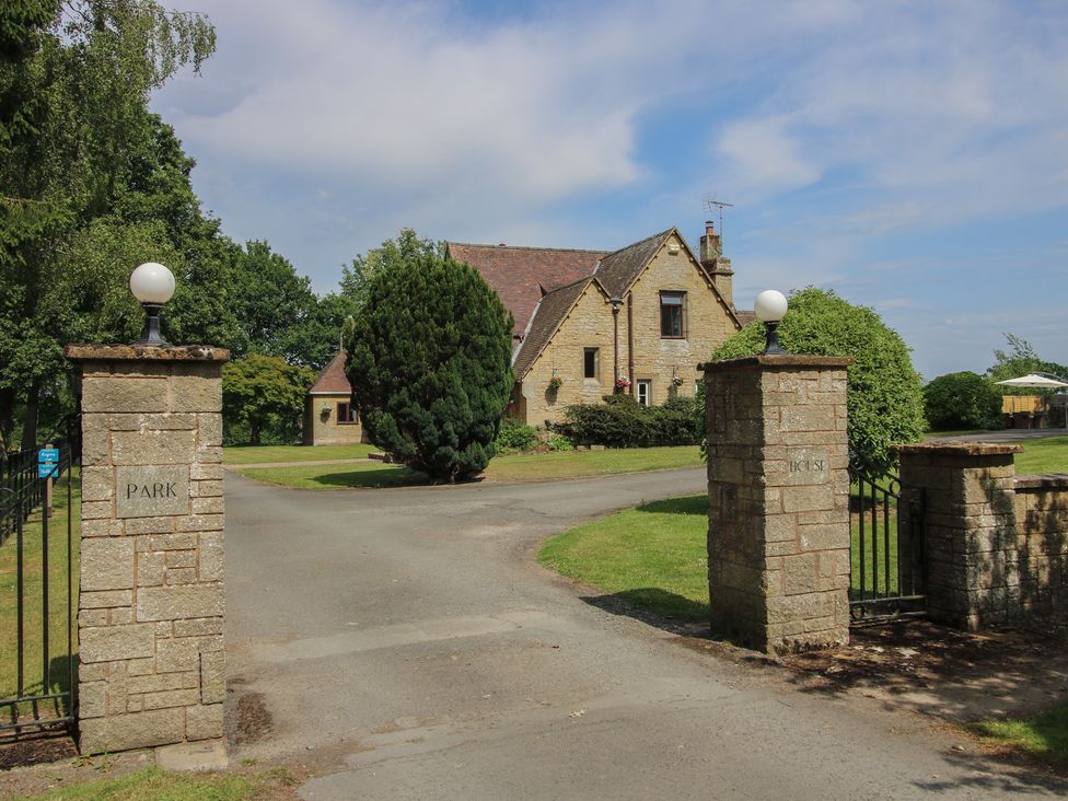 A house surrounded by trees and grass at Keepers Cottage in Shobdon