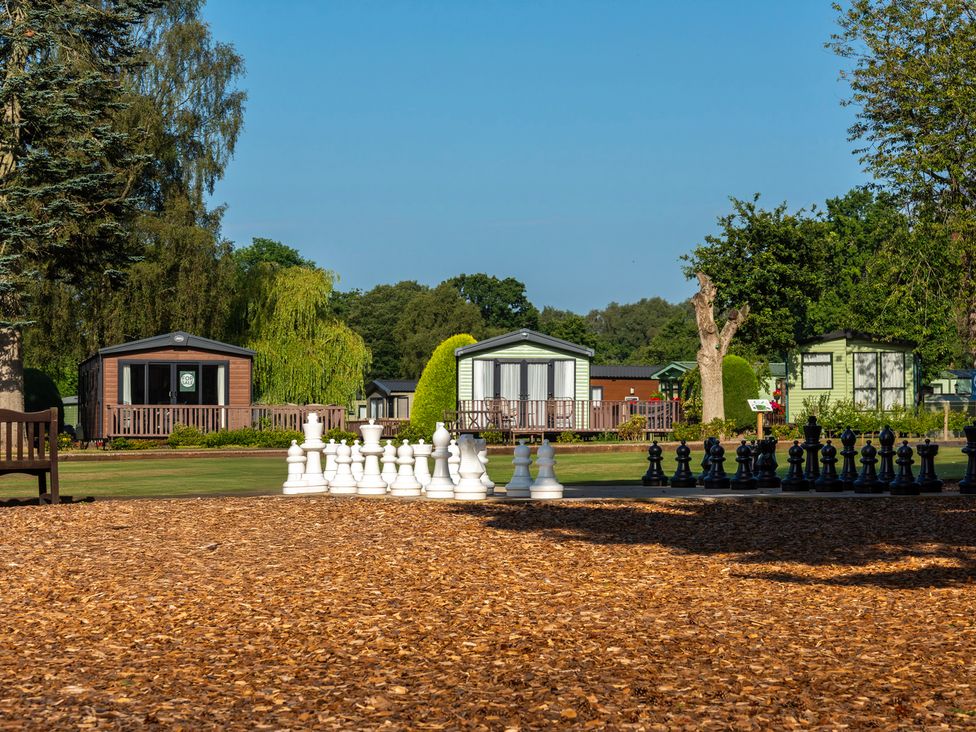 An outdoor area with large chess pieces and holiday homes at Keepers Cottage in Shobdon