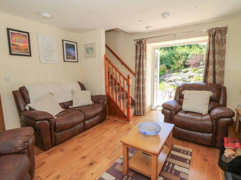 A living room with a sofa and coffee table at Felin Gogoyan in Tregaron