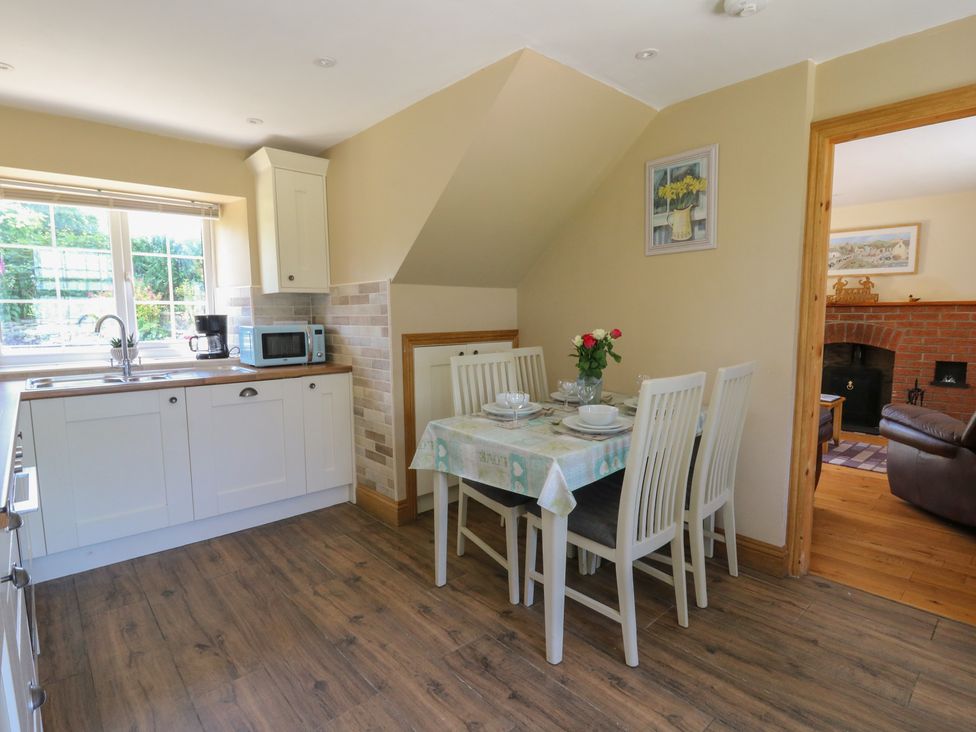 A kitchen with a dining area and appliances at Felin Gogoyan Tregaron