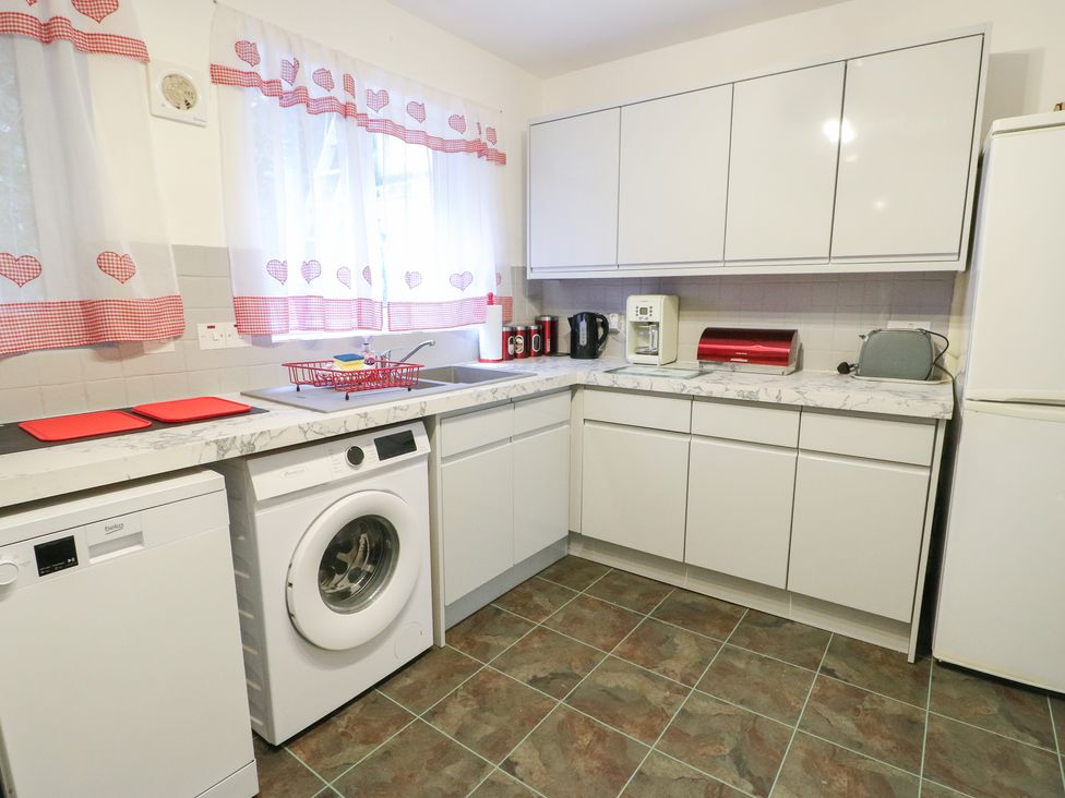 A kitchen with appliances and cabinets at 23 Beach Road in Y Felinheli