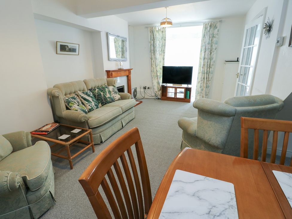 A living room with a sofa and television at 23 Beach Road Y Felinheli