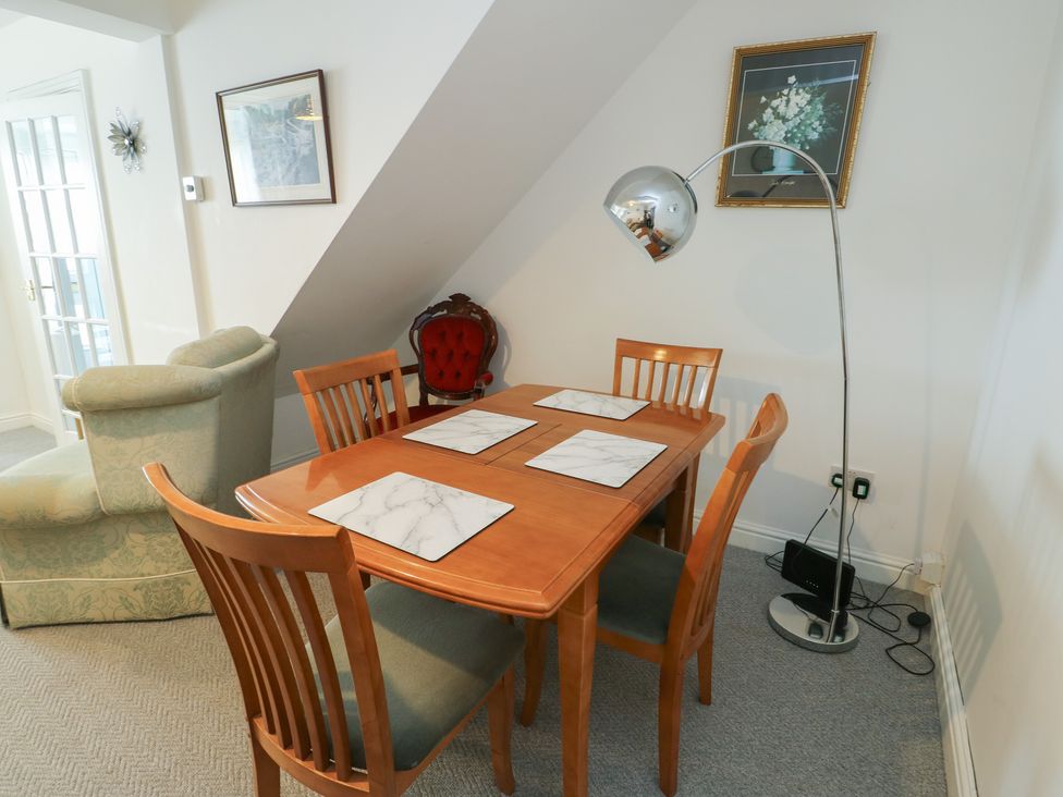 A dining room with a table and chairs at 23 Beach Road in Y Felinheli