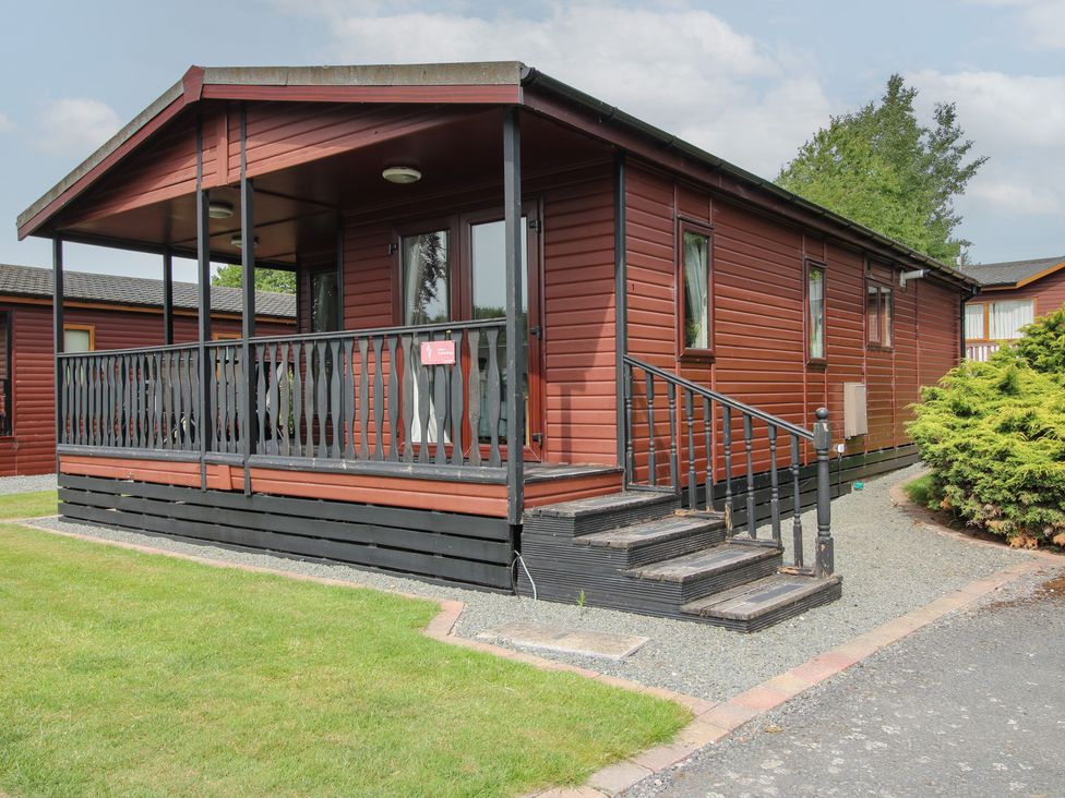 A log cabin with a porch and steps at Snowdrop in Eardisland