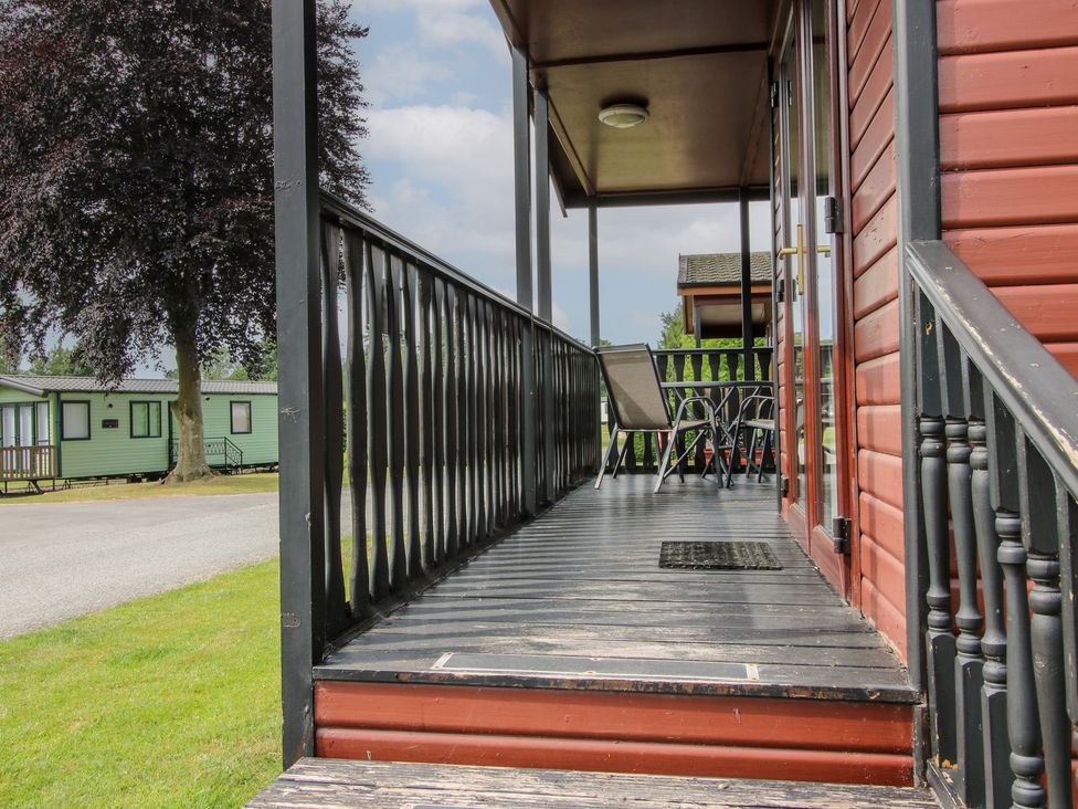 A deck with steps and chairs at Snowdrop in Eardisland