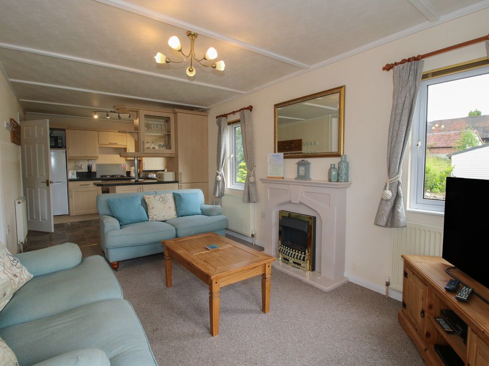 A living room with a sofa and coffee table at Snowdrop in Eardisland