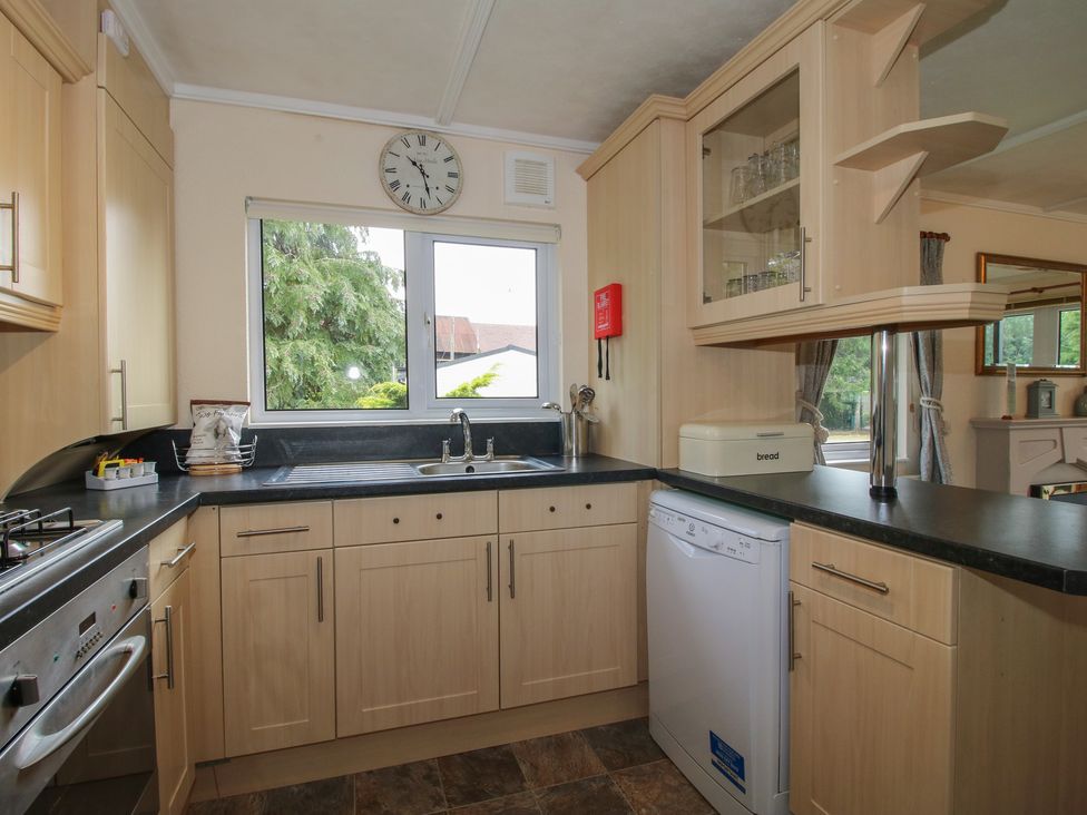 A kitchen with a sink and dishwasher at Snowdrop in Eardisland
