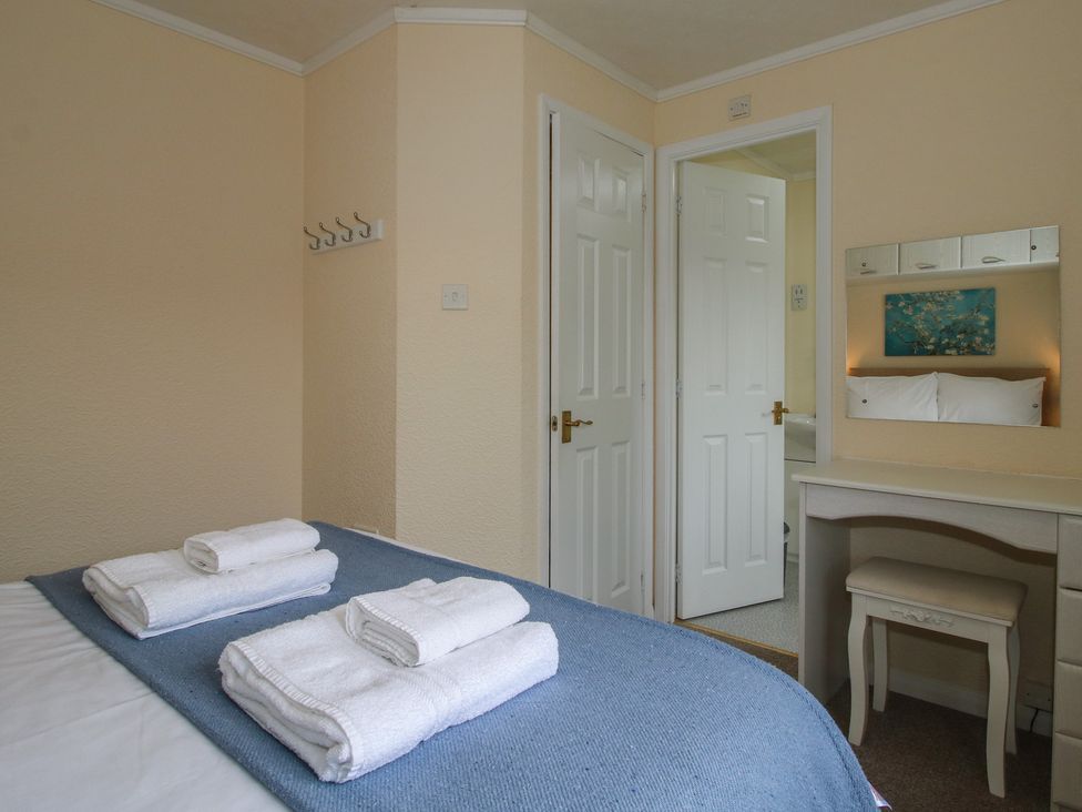 A bedroom with towels on a bed at Snowdrop in Eardisland
