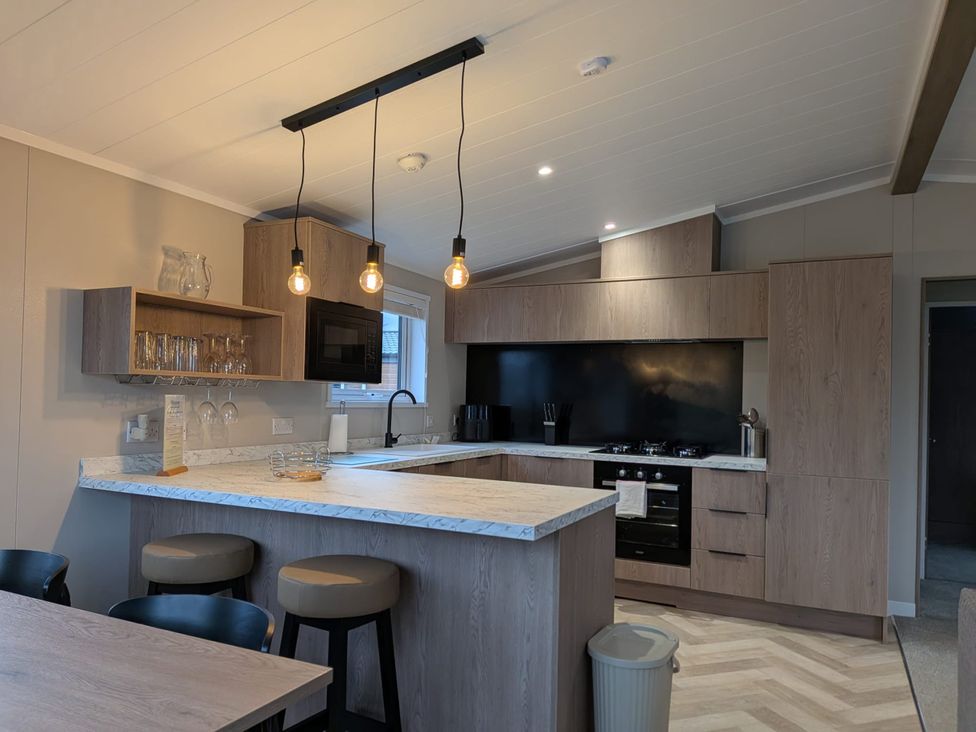 A kitchen with modern appliances and furnishings at Snowdrop in Eardisland