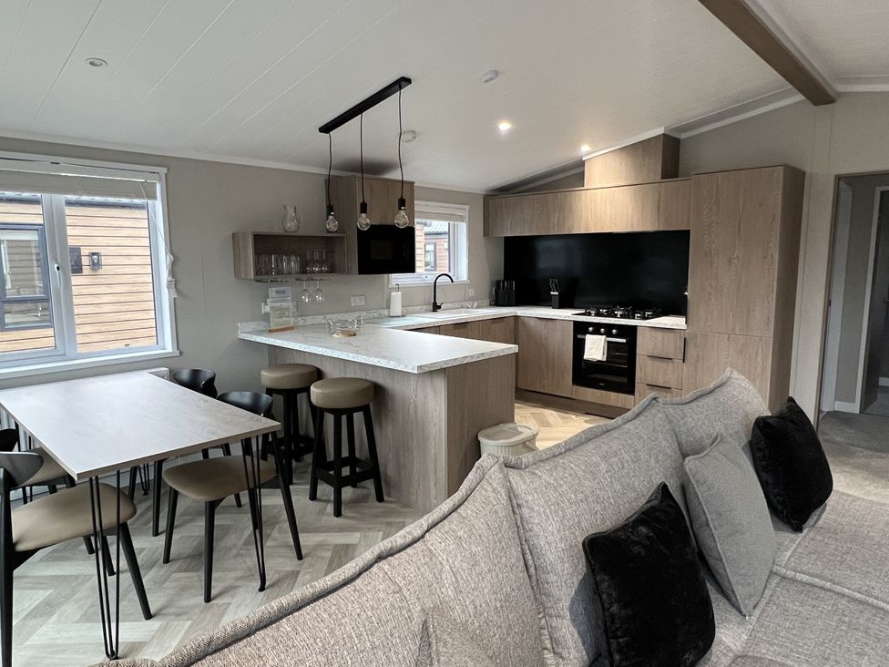 A kitchen with an island and dining table at Snowdrop in Eardisland