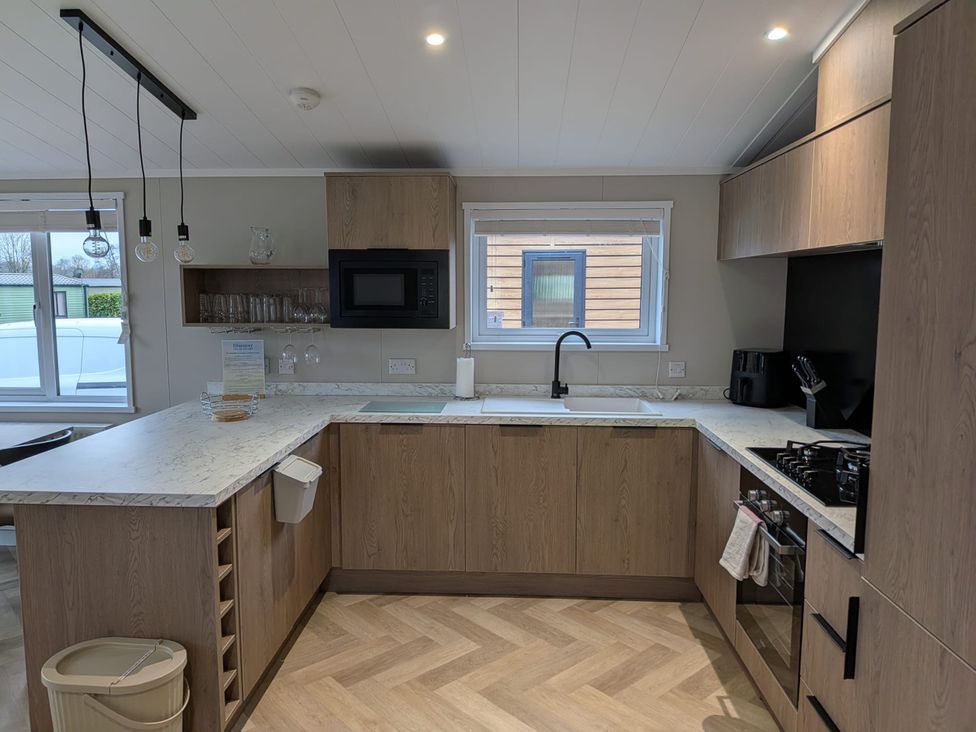 A kitchen with cabinets and countertop at Snowdrop in Eardisland