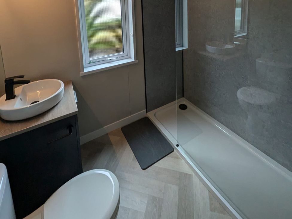A bathroom with a sink and shower at Snowdrop in Eardisland