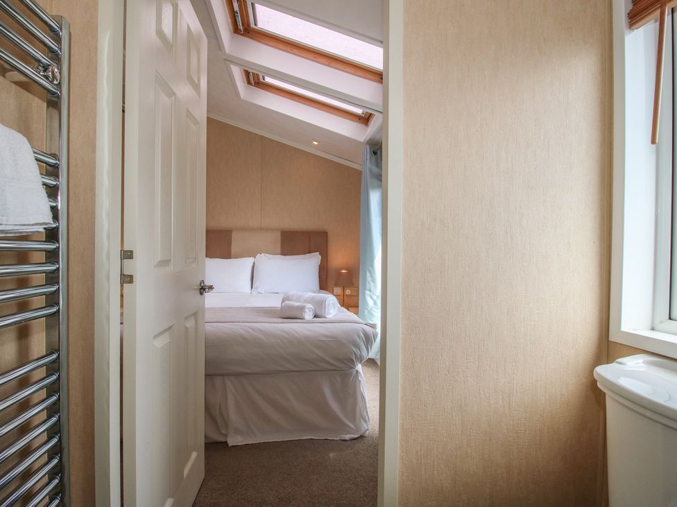 A bedroom with a bed and towels at Daisy in Eardisland