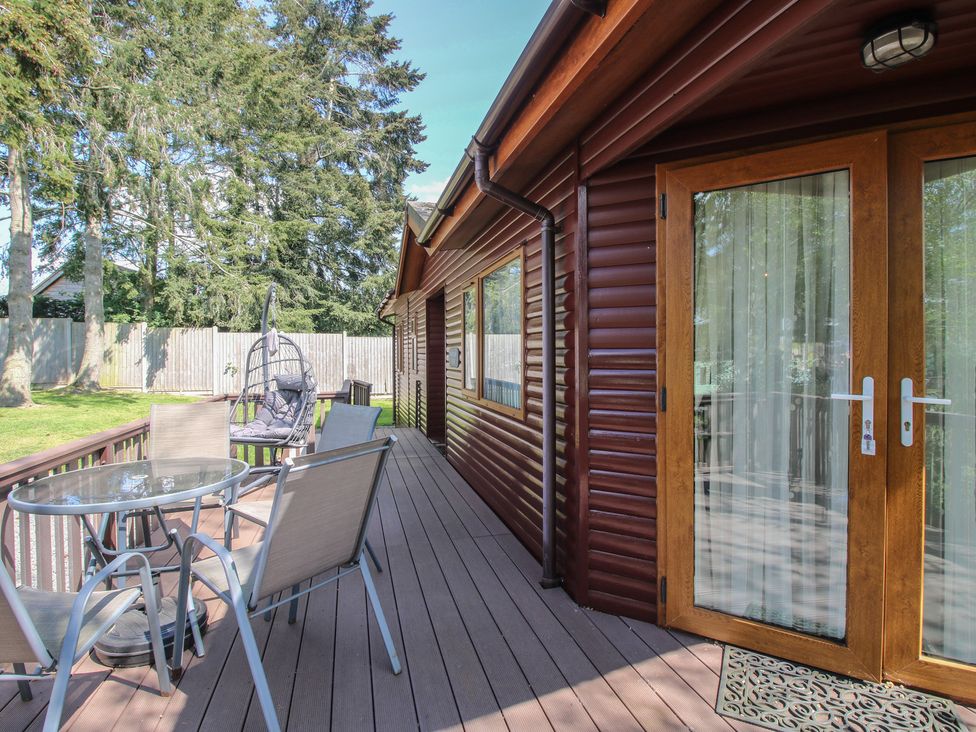 A deck area with a table and chairs at Foxglove in Eardisland