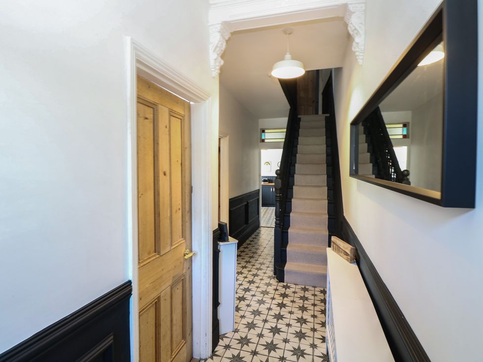 A hallway with a staircase and a door at Sunrise House Pakefield near Lowestoft