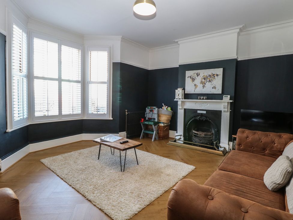 A living room with a sofa and a coffee table at Sunrise House Pakefield near Lowestoft