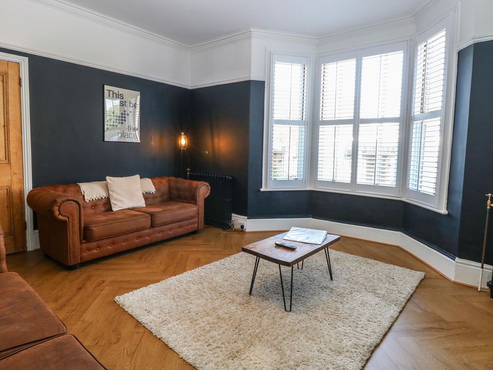 A living room with a sofa and coffee table at Sunrise House in Pakefield near Lowestoft