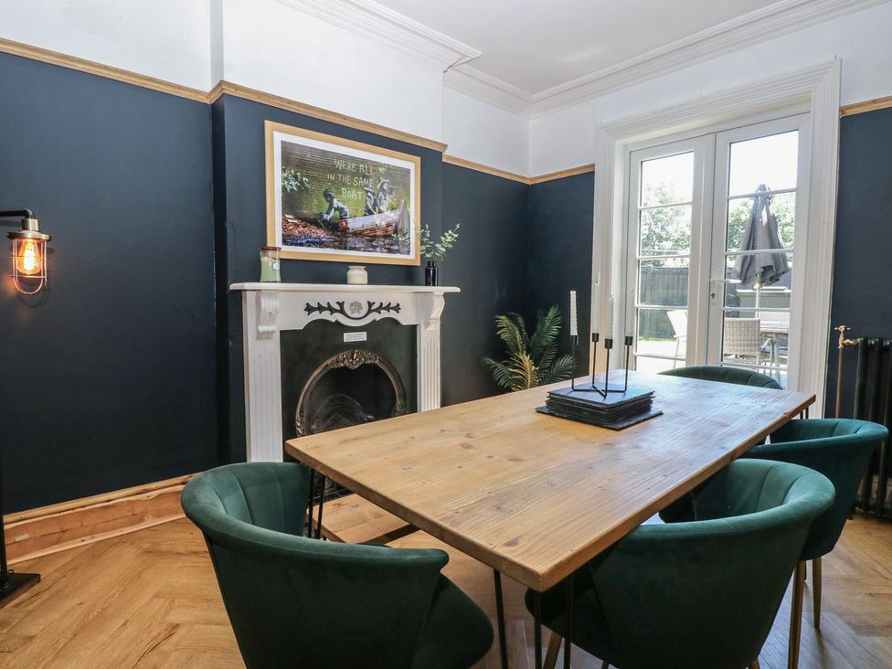 A dining room with a table and chairs at Sunrise House in Pakefield near Lowestoft