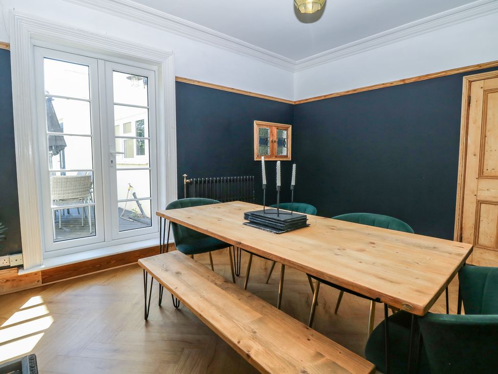 A dining room with a wooden table and chairs at Sunrise House Pakefield near Lowestoft