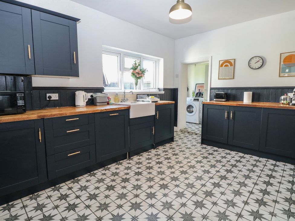A kitchen with cabinets and sink at Sunrise House near Pakefield