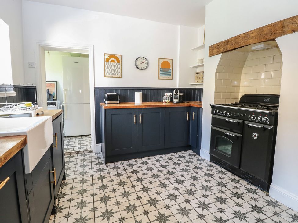 A kitchen with cabinets and an oven at Sunrise House in Pakefield near Lowestoft
