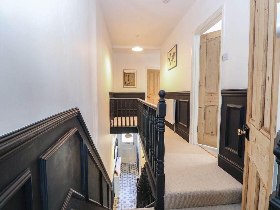 A hallway with staircase and doors at Sunrise House Pakefield near Lowestoft