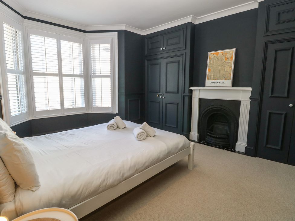 A bedroom with a bed and towels at Sunrise House Pakefield near Lowestoft