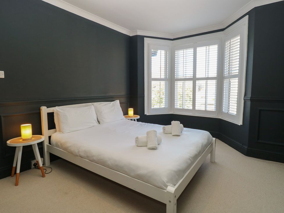 A bedroom with a bed and bedside tables at Sunrise House in Pakefield near Lowestoft