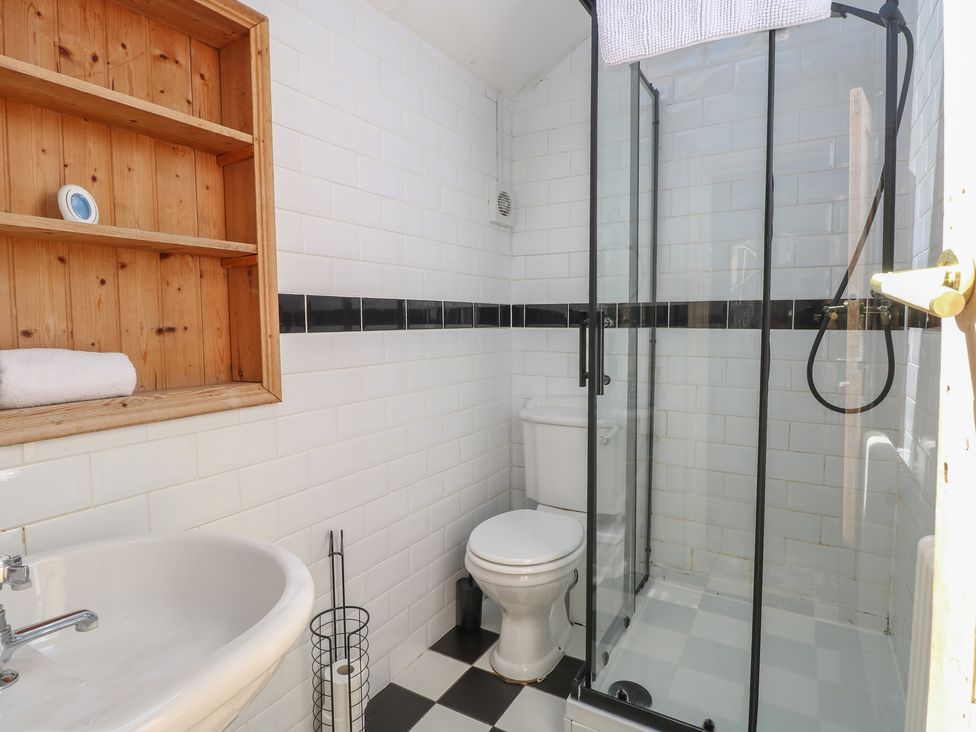 A bathroom with a shower, toilet, and sink at Sunrise House Pakefield near Lowestoft