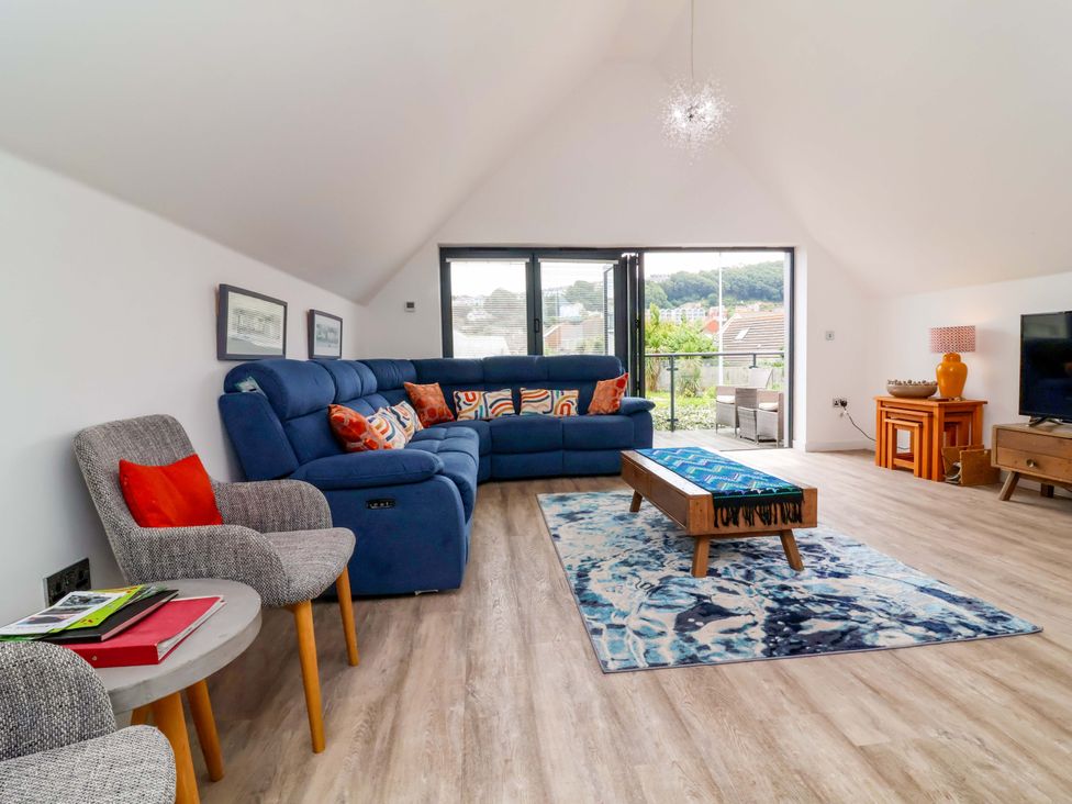 A living room with a sofa and television at Pebble Ridge View Westward Ho!