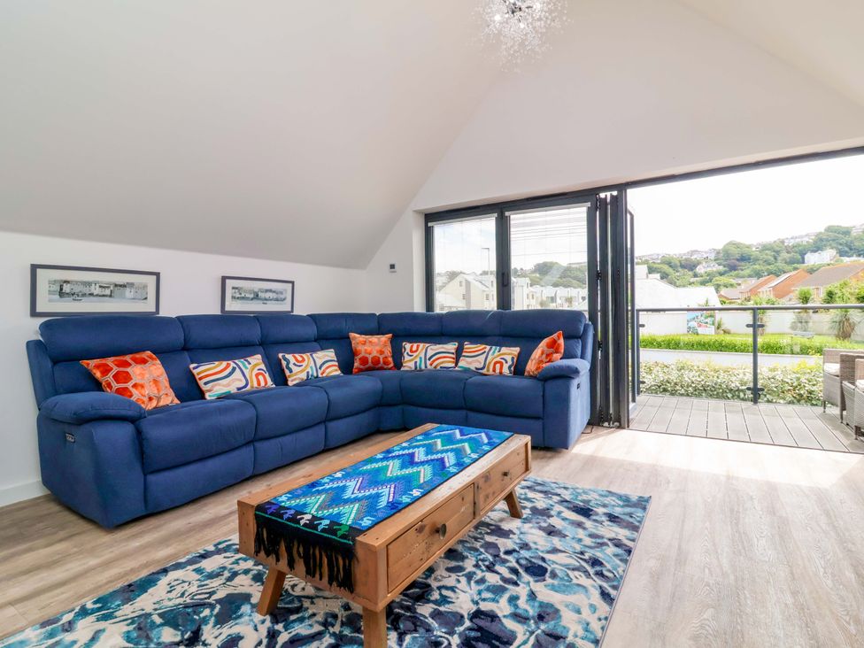 A living room with a blue sofa and coffee table at Pebble Ridge View in Westward Ho!