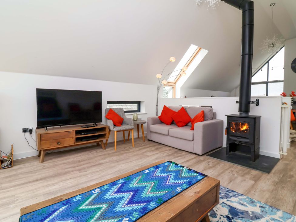 A living room with a television and sofa at Pebble Ridge View in Westward Ho!