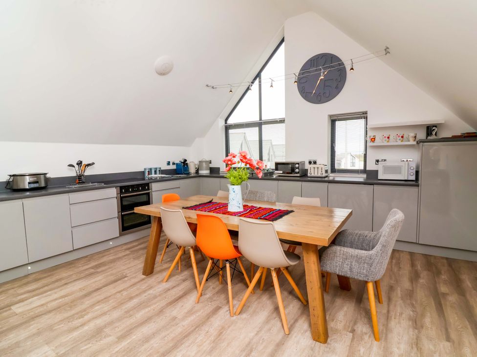 A kitchen with a dining table and chairs at Pebble Ridge View in Westward Ho!