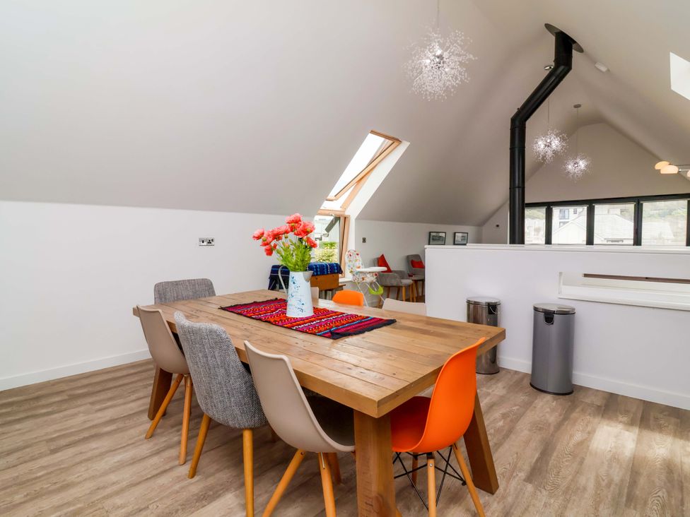 A dining room with a table and chairs at Pebble Ridge View in Westward Ho!