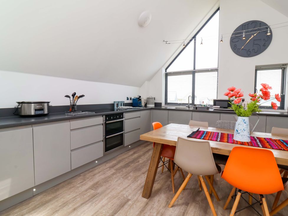 A kitchen with a table and chairs at Pebble Ridge View in Westward Ho!
