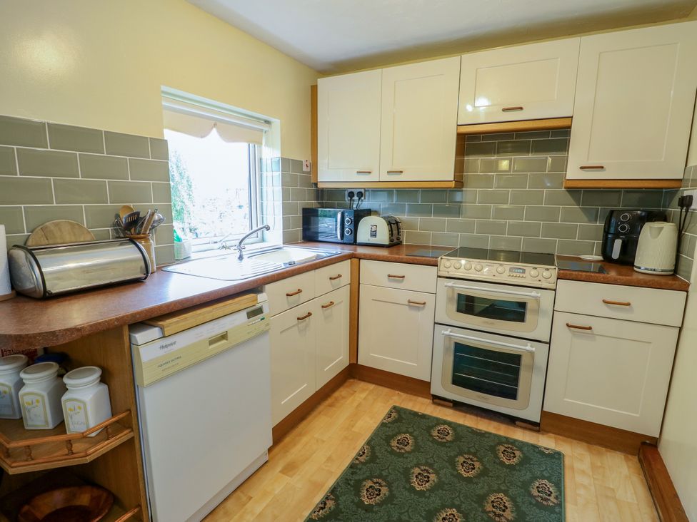 A kitchen with sink and appliances at The Cottage at Ty Newydd in Brynsiencyn